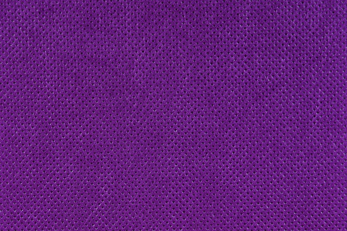 Purple perforated stretch fabric shown in macro